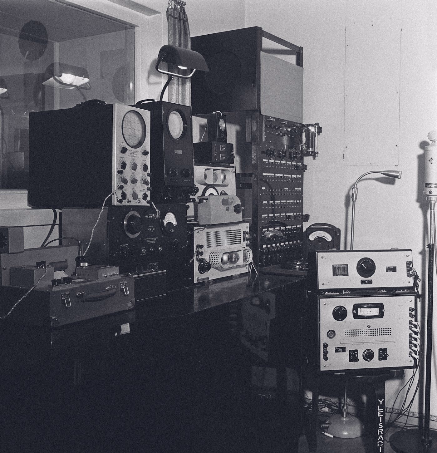 A vintage recording studio full of equipment, black and white
