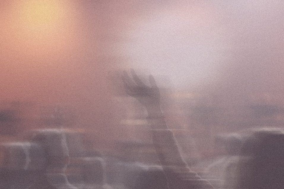 A concert crowd in soft peach haze